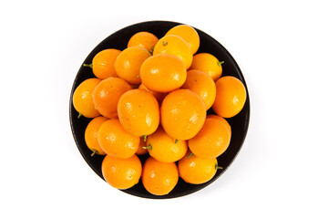 ripe cumquat or kumquat fruit in plate isolated on white background