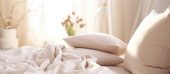 A cozy bed with white linens and pillows made of soft cotton, placed in a room with hardwood floors...