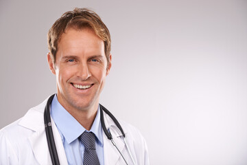Man, doctor and smile in studio, portrait and medical professional on gray background. Male person,...