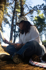 a woman reading a book in a forest in southern Chile