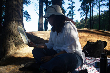a woman reading a book in a forest in southern Chile