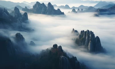 Fotobehang the surreal beauty of mountains shrouded in thick fog  © Pumapala