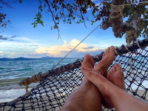 Relaxing Hammock View: Feet Up on Tropical Beach Getaway in Thailand, Island Life