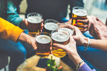 Group of people drinking beer at brewery pub restaurant - Happy friends enjoying happy hour sitting at bar table - Closeup image of brew glasses - Food and beverage lifestyle concept - obrazy, fototapety, plakaty