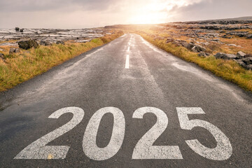 Sign 2025 on asphalt road in a beautiful country setting with dramatic cloudy sky with sun flare at sunrise. Plans and travel concept. Forecasting events in period of time.