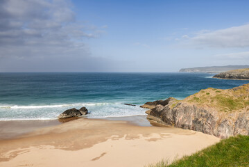 Fototapeta na wymiar The unspoiled charm of Durness Beach, Scotland, is evident in the gentle embrace of azure waters against the pristine sandy shore