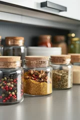 Foto auf Leinwand Organized Spice Jars on Kitchen Shelve. Array of assorted different dry spices in glass jars neatly lined up, organization of order. © SnowElf