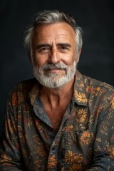 Elderly man smiling at camera. A close-up portrait of an elderly, man with a warm smile, wearing fashionable clothes.