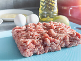 Fresh minced pork with egg, salt oil  on the kitchen table
