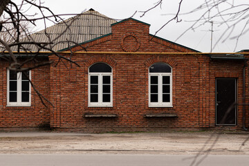 Entrance and windows in a single-family house made of red brick