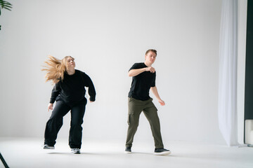 young male and female pair Practicing a Dynamic Routine, doing modern dance choreography