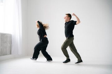 Energetic Couple Dancing Together in a Bright interior Setting - 762187314