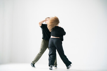 Contemporary Dance Duo Performing Routine Moves in a white Studio - 762187387