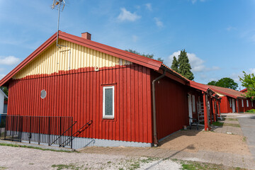 Painting of a wooden house in red color. Red Scandinavian Swedish style of houses.