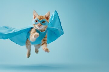 superhero cat, Cute orange tabby kitty with a blue cloak and mask jumping and flying on light blue background with copy space. The concept of a superhero, super cat, leader, funny animal studio shot