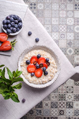 oatmeal porridge with strawberries blueberries and honey