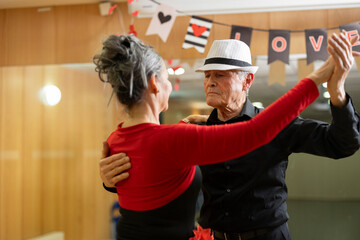 close up senior man grandfather learning to dance in workshop of retired seniors