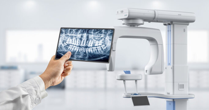 Dentist analyze digital x-ray film from scanner machine