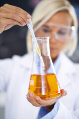Science, study and woman with liquid in beaker for medical research, vaccine innovation or...