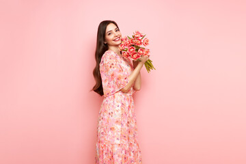 Happy beauty woman with pink tulip bouquet on light pink background. 8th of March celebration - 762200925