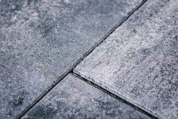 The photo highlights the subtle variations in color and texture of the concrete pavement, adding depth and dimension to the image.background