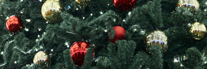 Festive New Year Christmas tree decorated red yellow Christmas balls with garlands lights, close up view, merry Christmas and happy New Year, essence of holiday cheer and joyous spirit