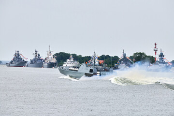 Military warship sailing along Russian naval forces parade warships along coastline, seafaring...
