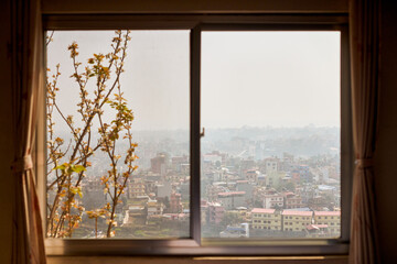 View of Kathmandu from hotel window through urban haze with lot of low rise buildings, cityscape creating an ethereal atmosphere in mountain air, Kathmandu air pollution