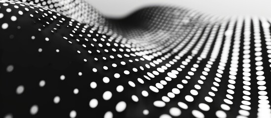 A monochrome closeup image of a wave pattern of dots on a black background. The circular dots create a meshlike texture in this striking monochrome photography