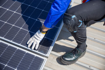 Technicians are installing and inspecting standards of solar panels on roof of an industrial...