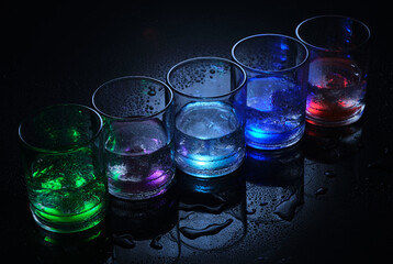 Vibrant glasses filled with colorful liquids and ice.