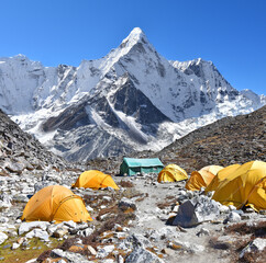 Climbers resting in a tent after hard day, base camp near the mount Ama Dablam in the Himalayas, beautiful sunny day with clouds and blue sky in Himalaya, Nepal