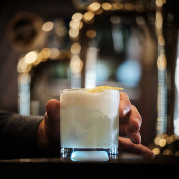 frosty cocktail with lemon garnish