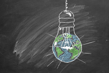 A light bulb with a globe inside, drawn in chalk on a school chalkboard. Earth hour concept. Save the world. Save our planet.