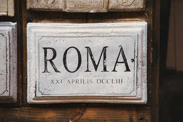 The word Rome and date carved in marble