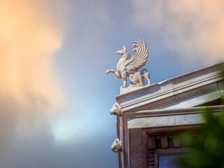 A Griffin statuette stands on the roof of Athens National University. Since antiquity, griffins...