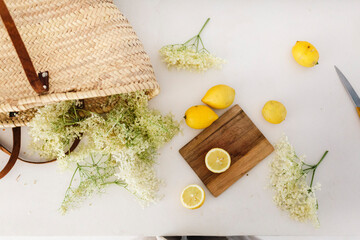 Fototapeta na wymiar Kitchen countertop with lemon and elderflower for making lemonade