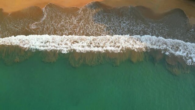 Bird's eye view of the wonderful Bom Bom beach, with the waves crashing causing beautiful images with the mixture of sand and sea foam at Prince Island,(ilha do Principe) Africa