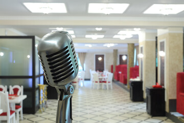 �ld-fashioned microphone standing in modern urban restaurant