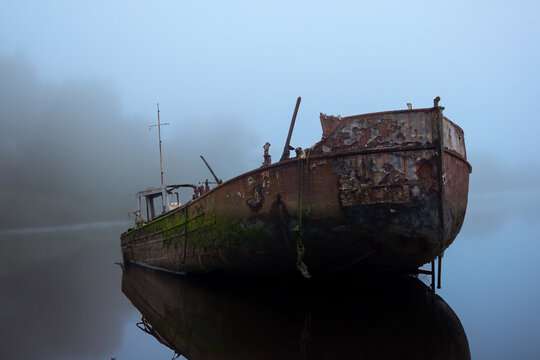 Abandoned boats at appledore in devon with water and mist added 