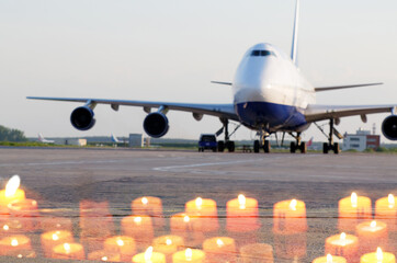 Collage with big jetplane parked at airport and burning candles, memory of lost passengers concept