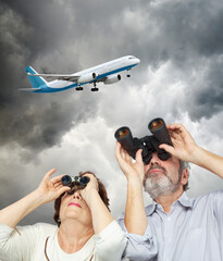 Collage with elderly couple looks through binoculars against backdrop of gray sky and flying...