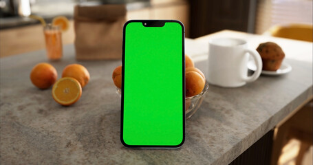 Smartphone place on kitchen table, Green screen telephone, Close up display mobile phone with mock...