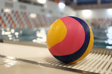 Ball for water polo in front of the pool, close-up