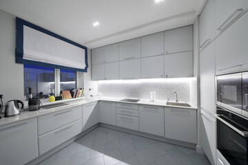 Interior of modern kitchen in the apartment in the evening