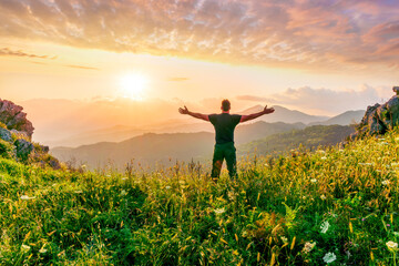 Fototapeta premium man doing hiking sport in mountains with anazing highland view