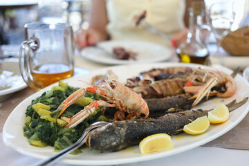 Dish with fish and seafood on the table in the restaurant
