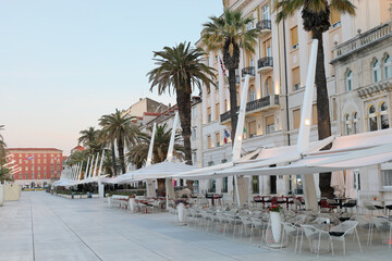 Empty cafe on Riva promenade in the early morning in Split