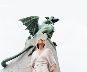 Young woman taking photo in front famous Dragon bridge in Ljubljana. Travel Explore Slovenia, Europe - 762270167
