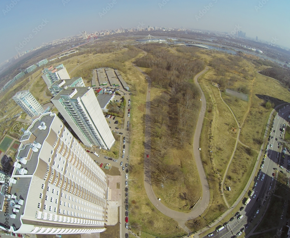 Wall mural speedway with turn near the residential buildings, aerial view